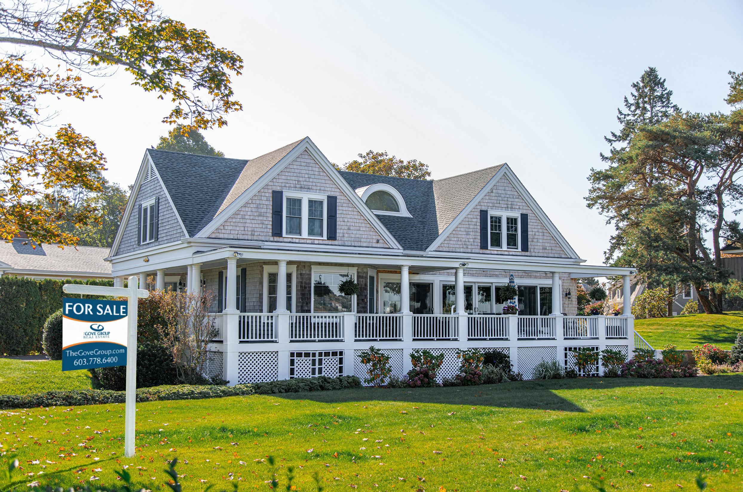 grey house with for sale sign